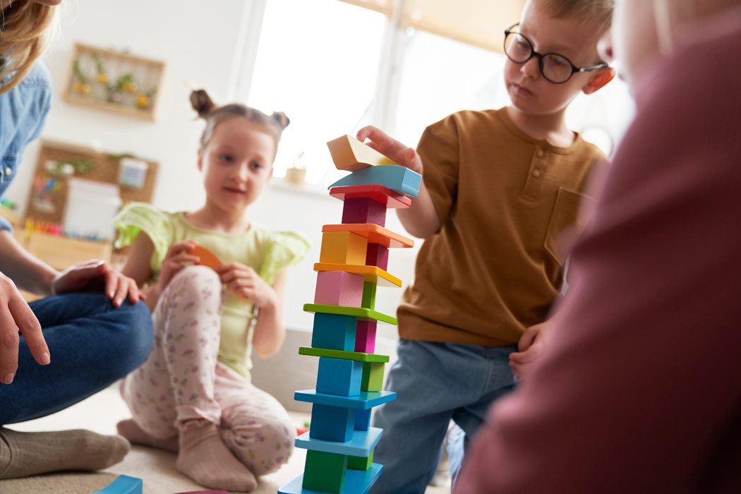 Children building with colorful blocks.