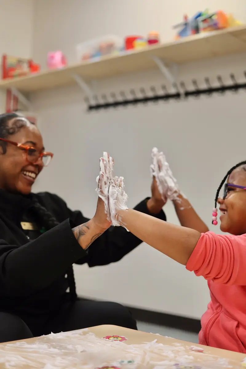 AB Spectrum team member and child connecting during a sensory activity